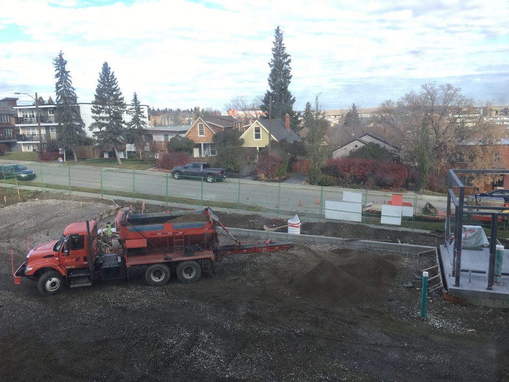 Concrete curbs were added around the perimeter of our parking areas and grading began in preparation of laying gravel and asphalt ahead.