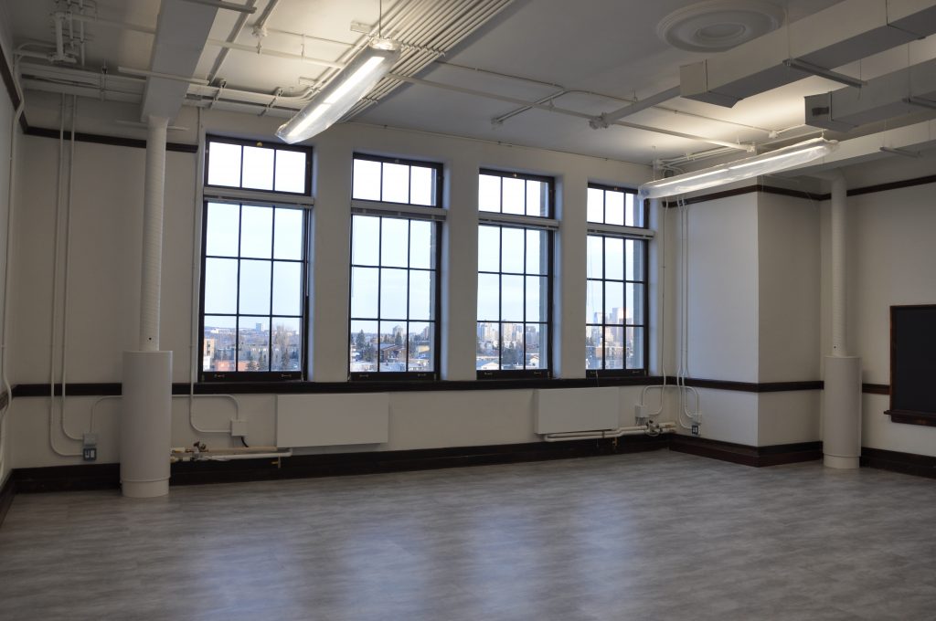 With lighting instruments now hung in most tenant spaces, the murkiness of construction lights has been replaced with even illumination from direct-indirect LED fixtures.